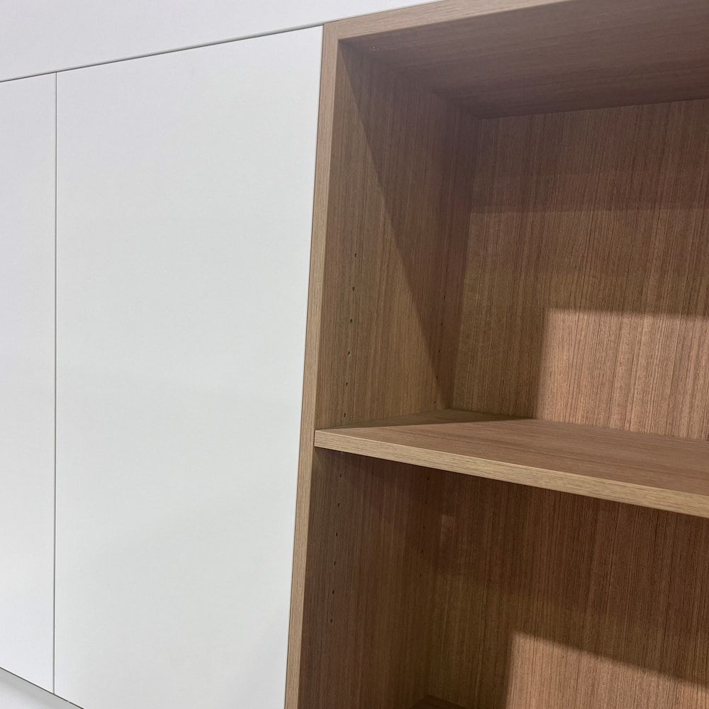 A Close Up Of A Wooden Shelf Next To A White Cabinet — Pioneer Cabinets in Airlie Beach, QLD
