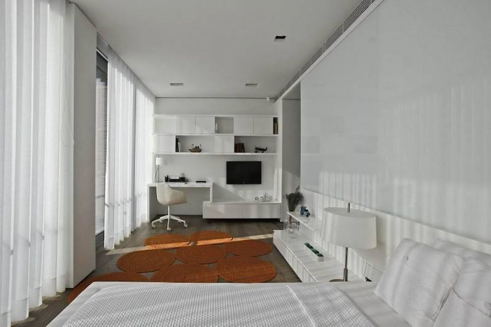 A Bedroom With A Bed, Desk And Television — Pioneer Cabinets in Moranbah, QLD