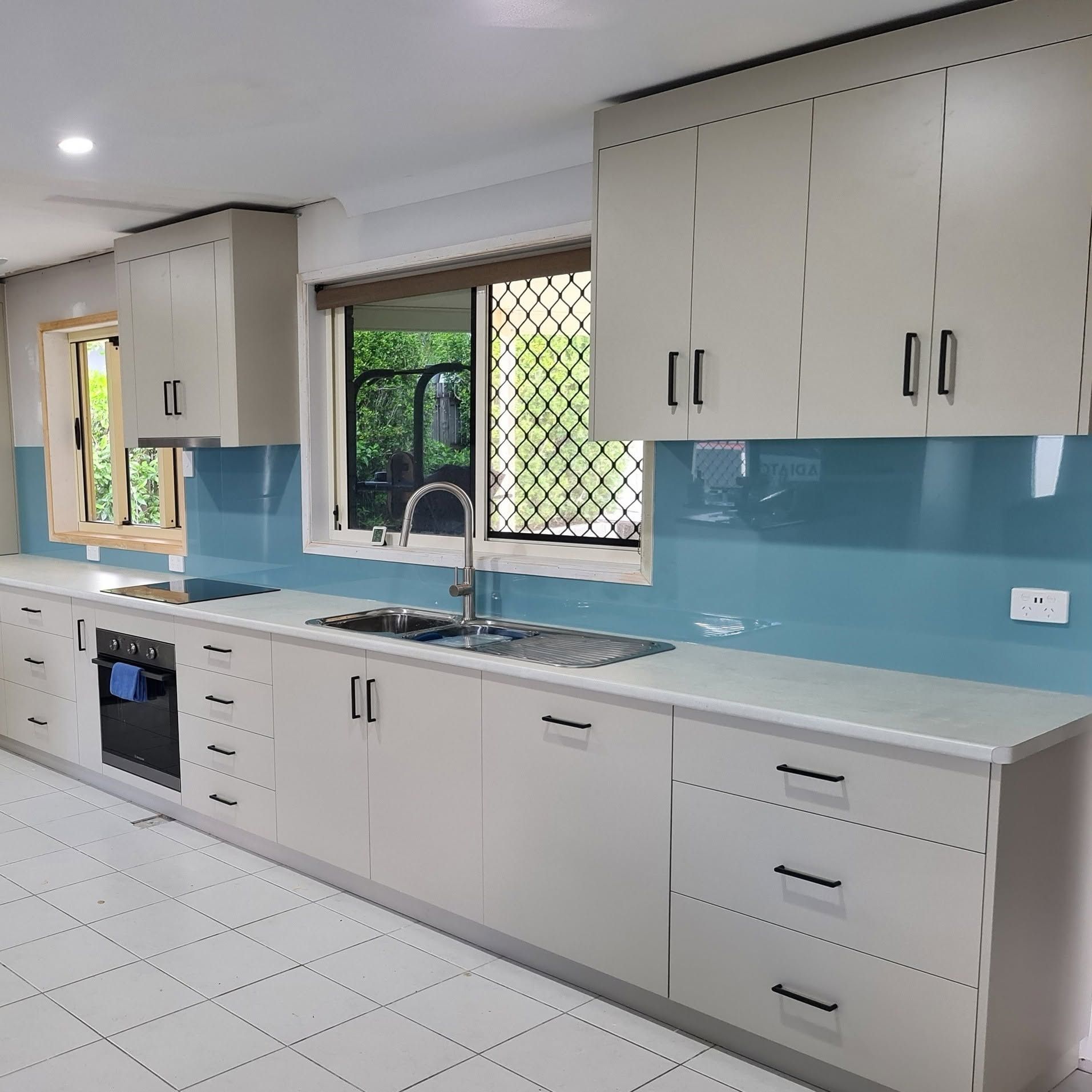 Kitchen cabinets Mackay modern white cabinetry.