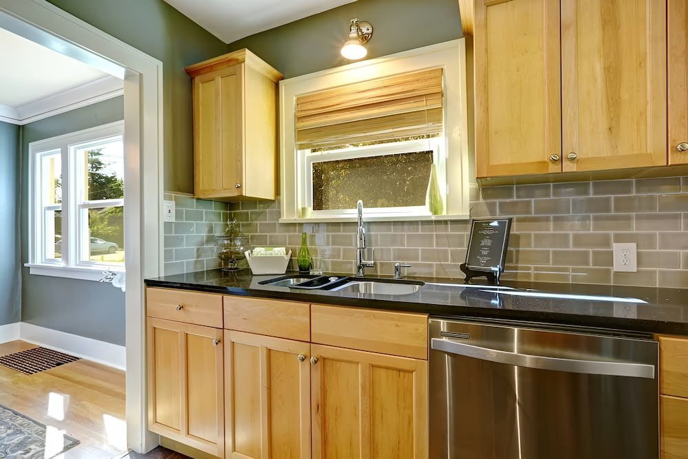 A Kitchen With Wooden Cabinets — Pioneer Cabinets in Paget, QLD