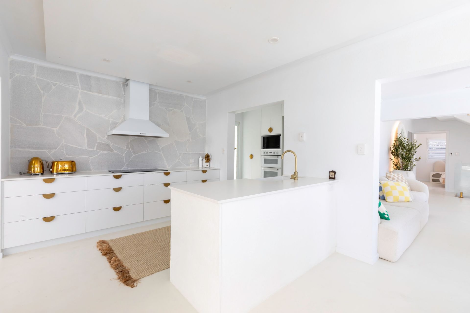 A Kitchen With White Cabinets And A Stove Top Oven — Pioneer Cabinets in Paget, QLD