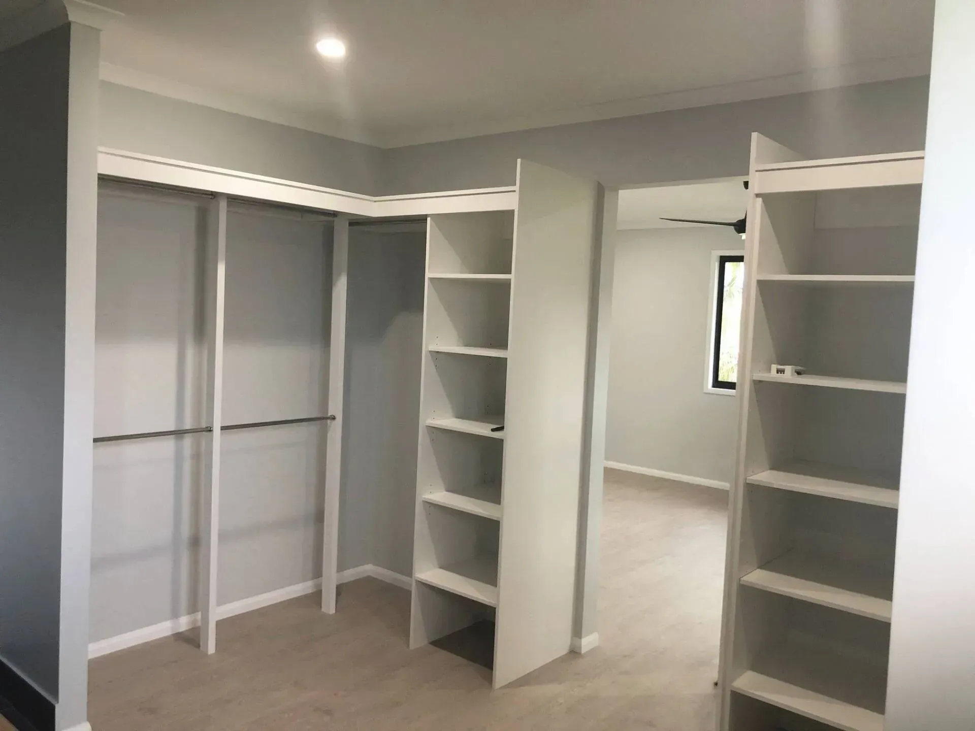 A Kitchen With A Wooden Countertop And White Shelves — Pioneer Cabinets in Paget, QLD