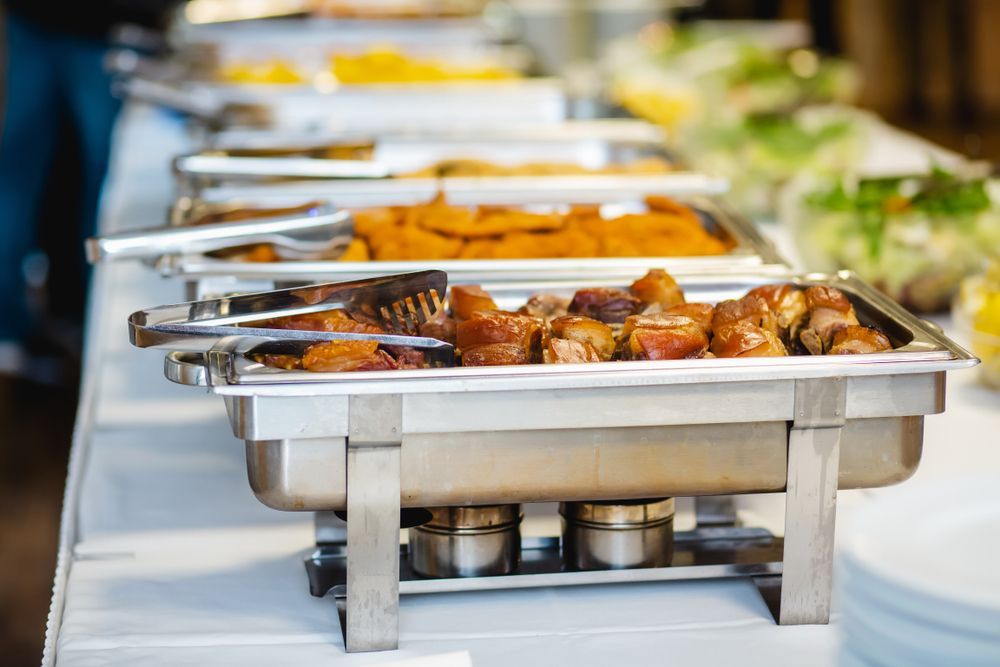 Buffet Table with Various Dishes in Chafing Dishes — Mount Louisa Snack Bar in Mount Louisa, QLD