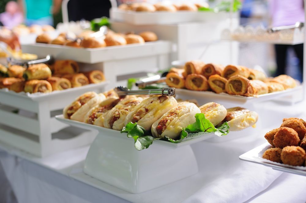 Buffet Table with Pastries and Small Bites on White Platters — Mount Louisa Snack Bar in Mount Louisa, QLD