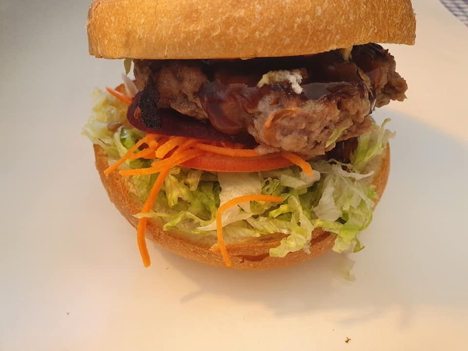 Chicken Sandwich with Lettuce, Tomato, Carrot and Sauce on A Bun — Mount Louisa Snack Bar in Mount Louisa, QLD