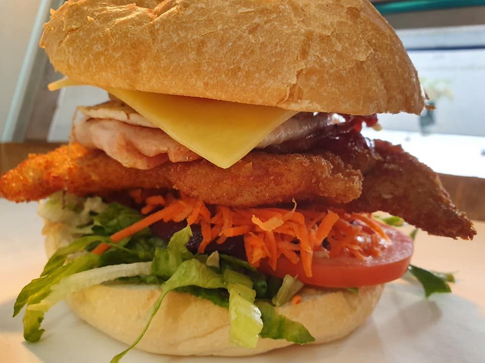 Burger with Breaded Chicken, Cheese and Vegetables — Mount Louisa Snack Bar in Mount Louisa, QLD