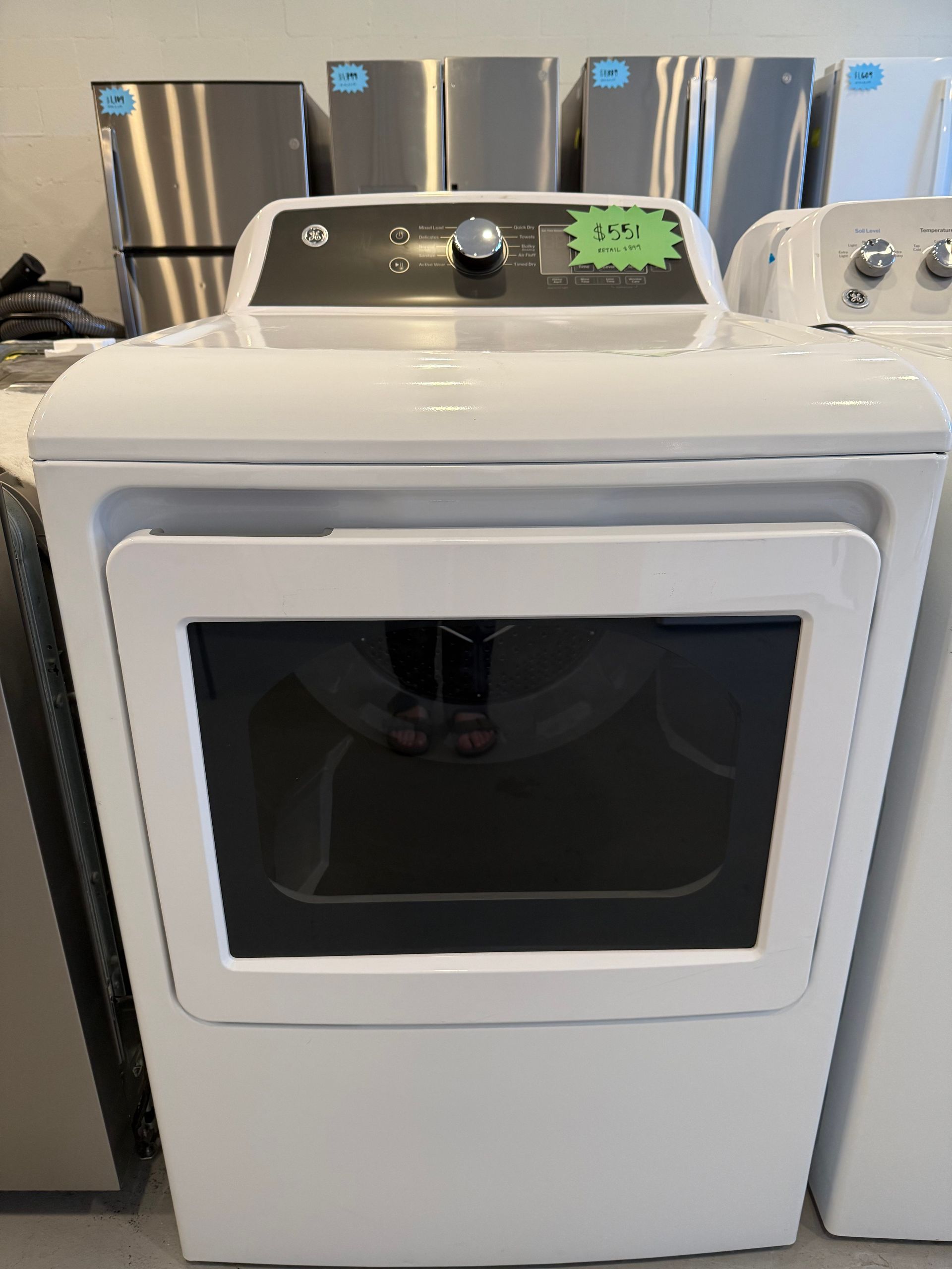 A white dryer is sitting on top of a counter in a store.