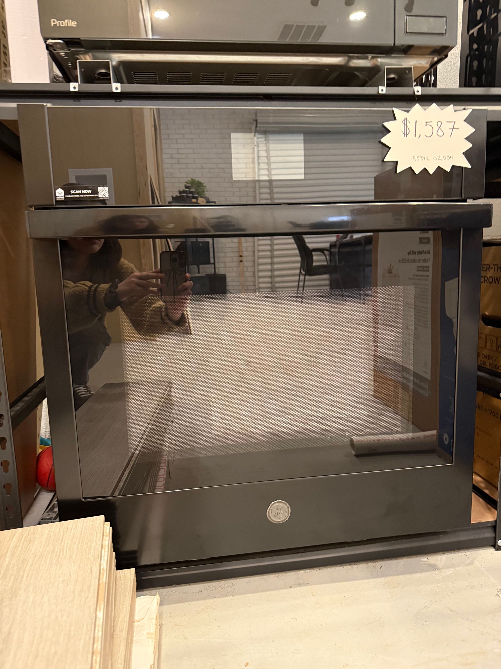 A black oven with a price tag on it is sitting on a counter.