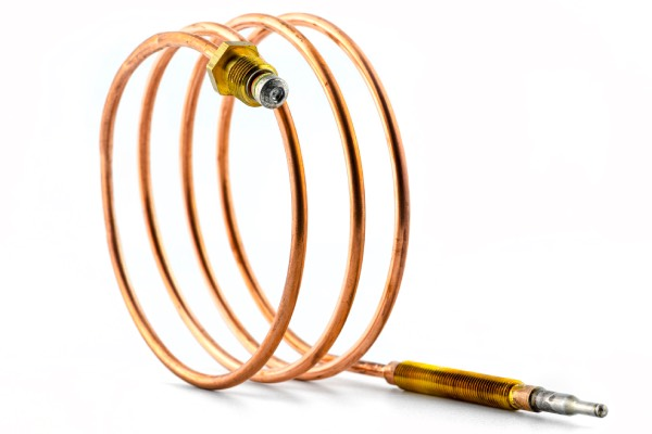 A close up of a copper pipe on a white background