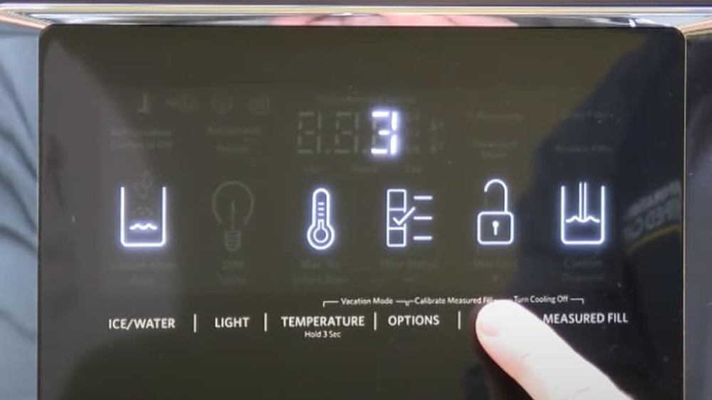 A person is pressing a button on a digital display