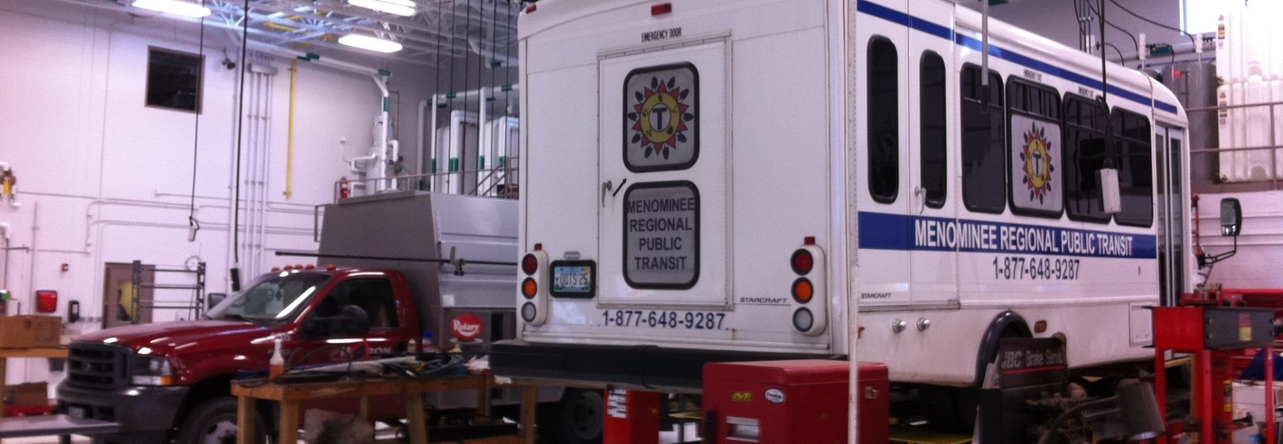 Menominee Regional Public Transit buses in a maintenance facility.