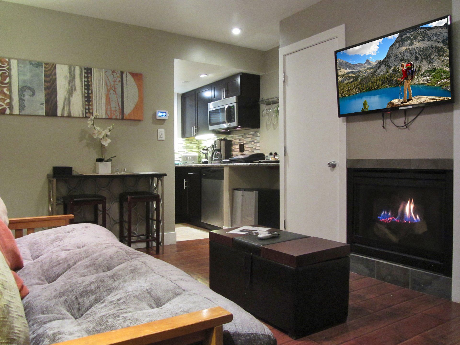 A living room with a fireplace and a flat screen tv