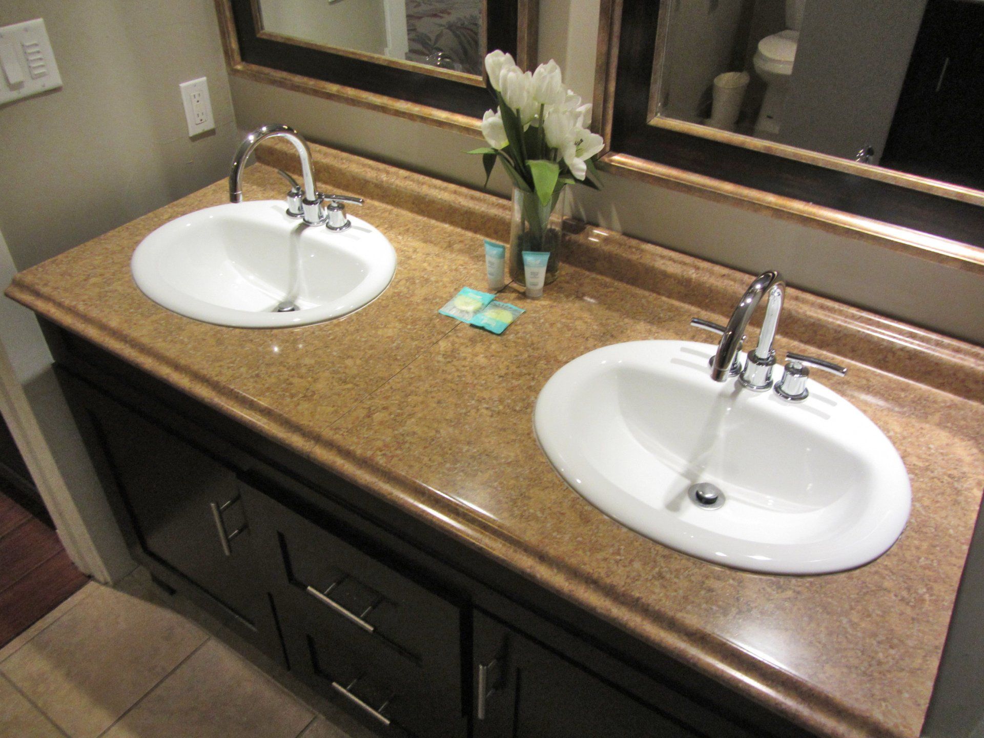 A bathroom with two sinks and a mirror