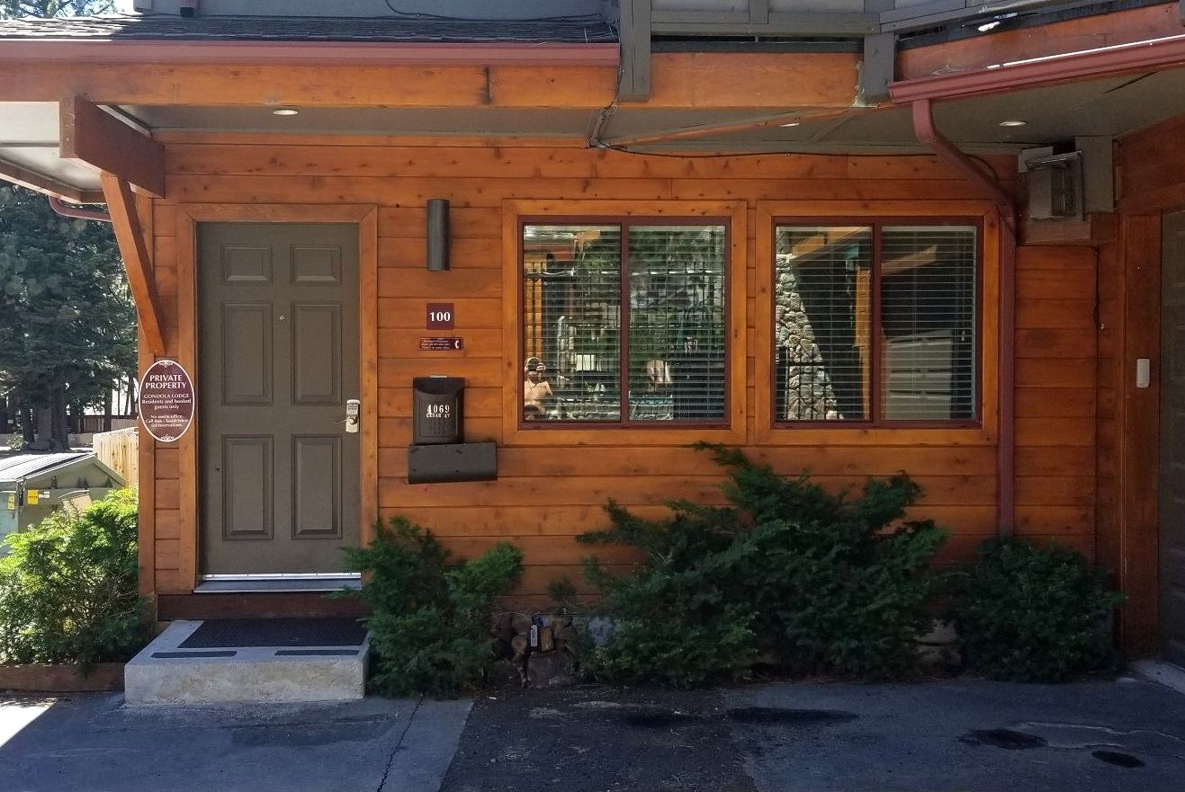 A wooden house with a mailbox in front of it