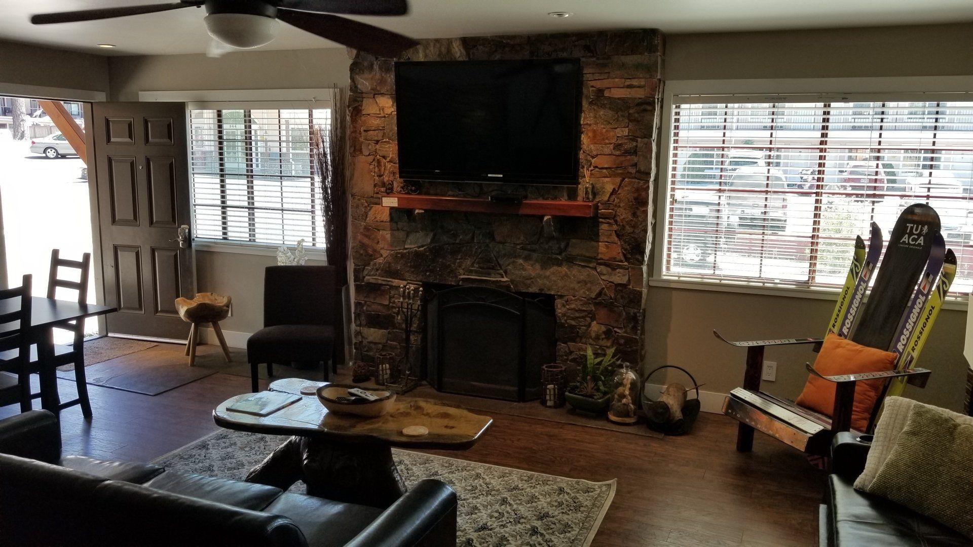 A living room with a fireplace and a flat screen tv.