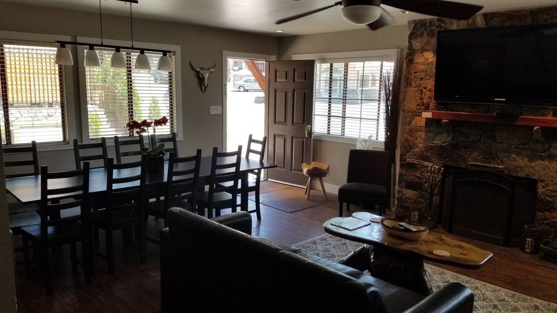 A living room with a table and chairs and a fireplace