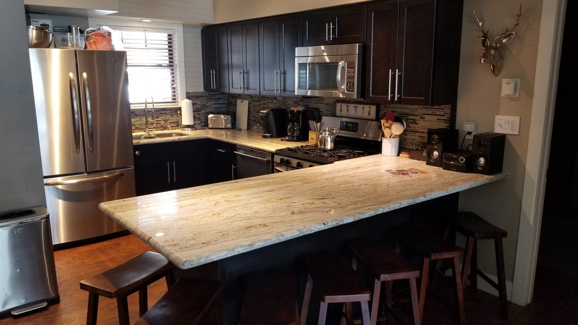 A kitchen with granite counter tops and stainless steel appliances
