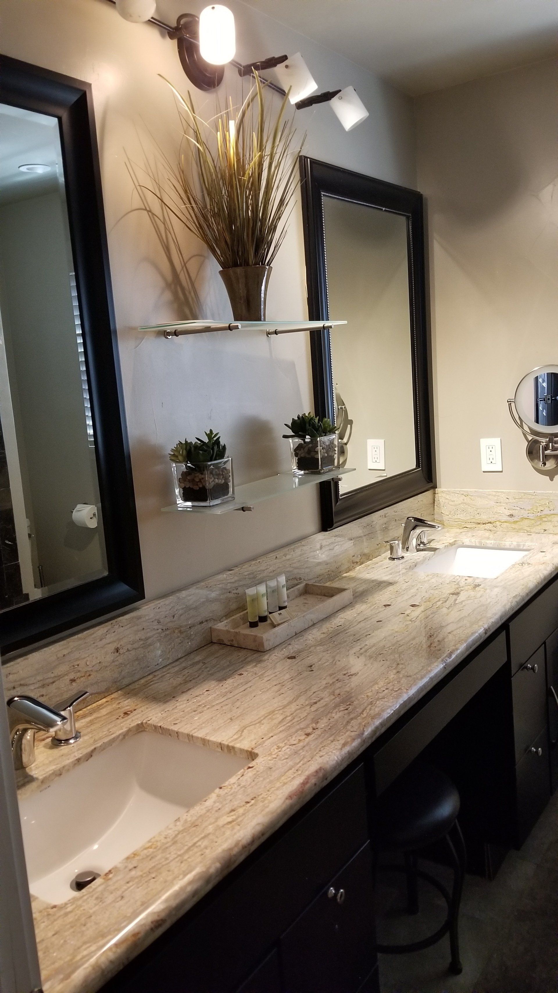 A bathroom with two sinks and two mirrors.