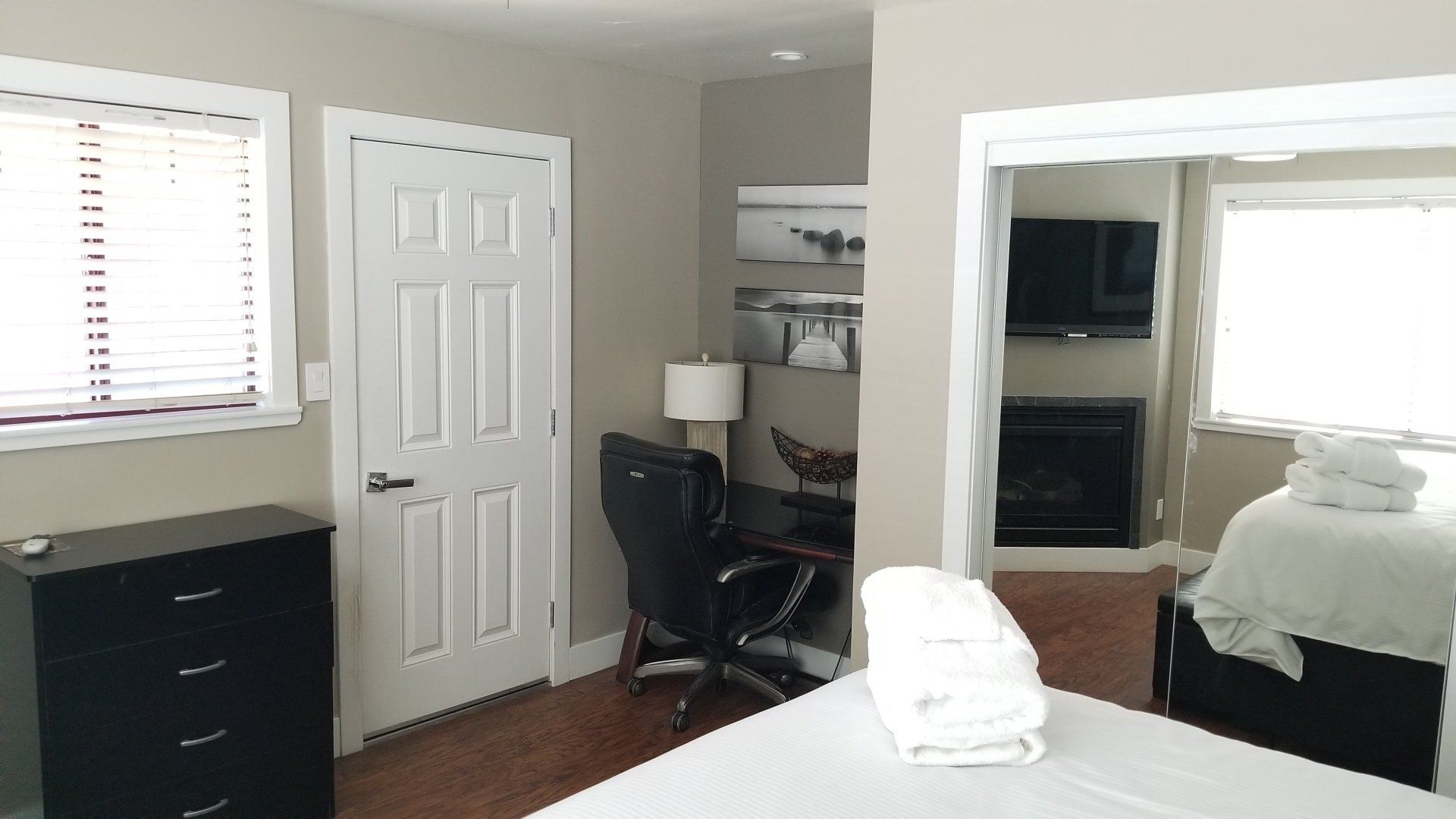 A bedroom with a bed , desk , chair and television.