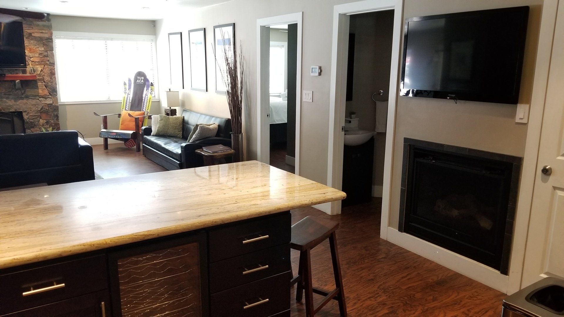 A living room with a fireplace and a flat screen tv