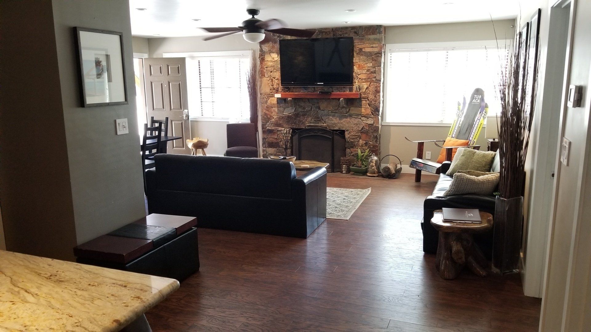 A living room with a fireplace and a flat screen tv
