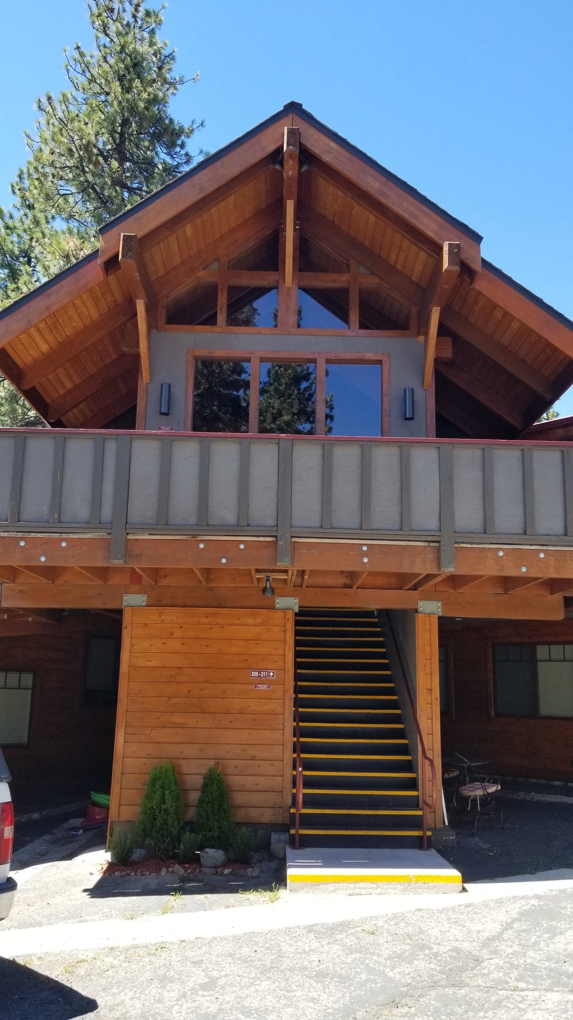 A large wooden house with stairs leading up to it
