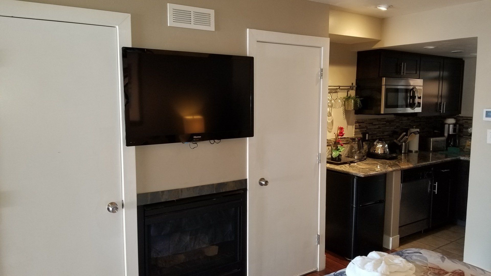 A living room with a fireplace and a flat screen tv.