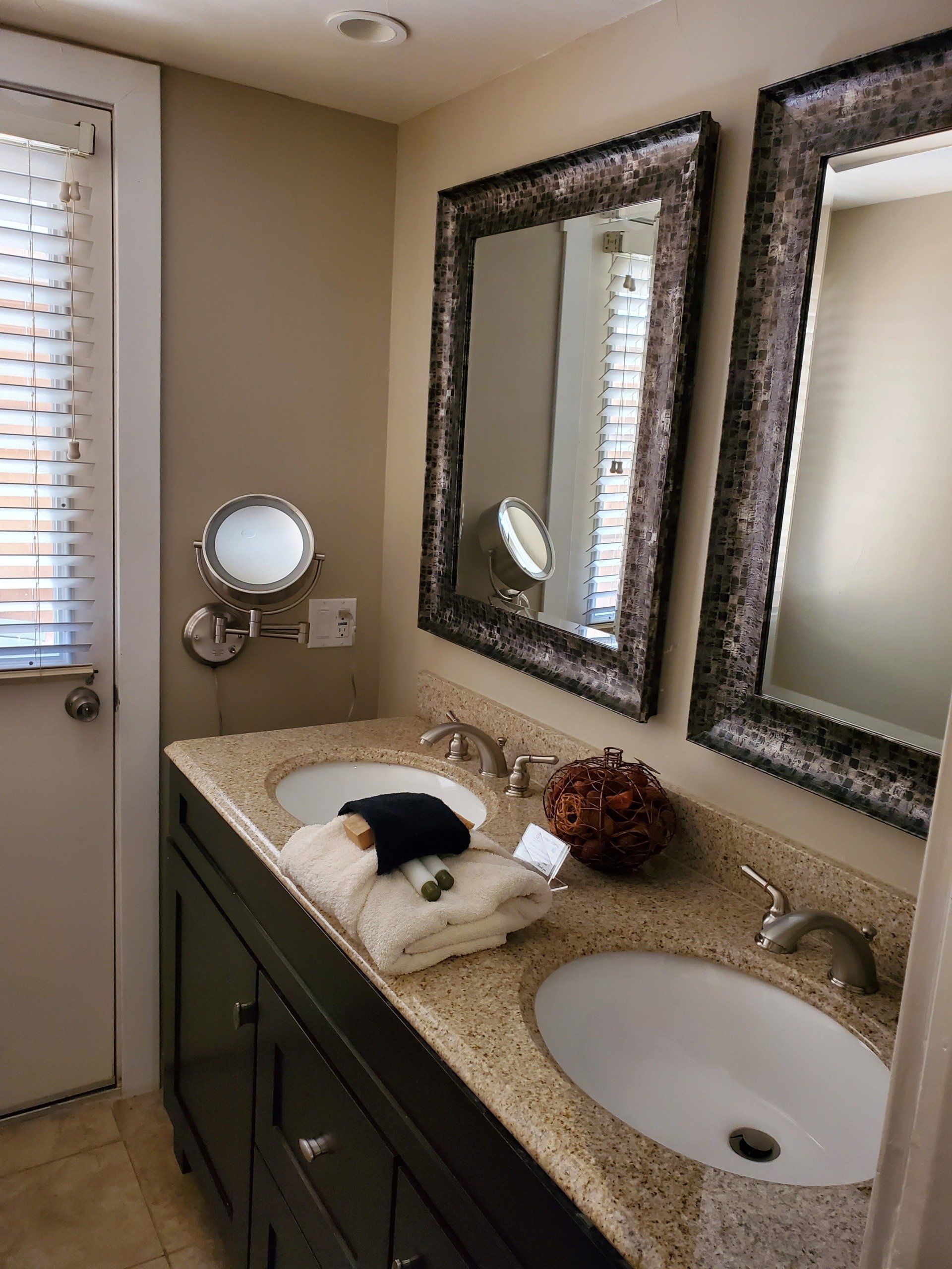 A bathroom with two sinks and two mirrors