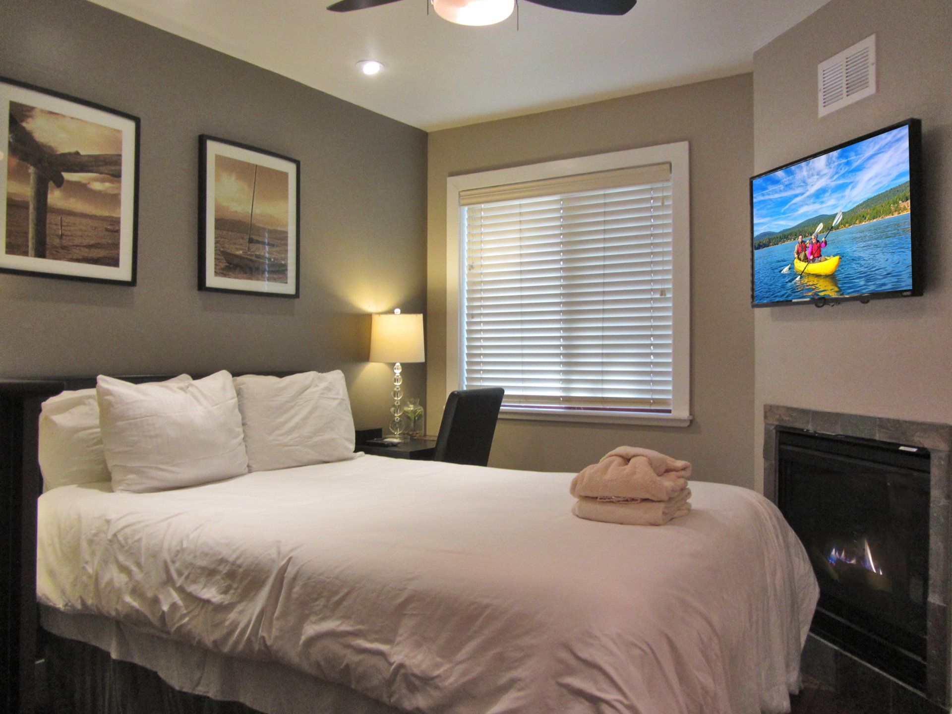 A bedroom with a king size bed and a flat screen tv