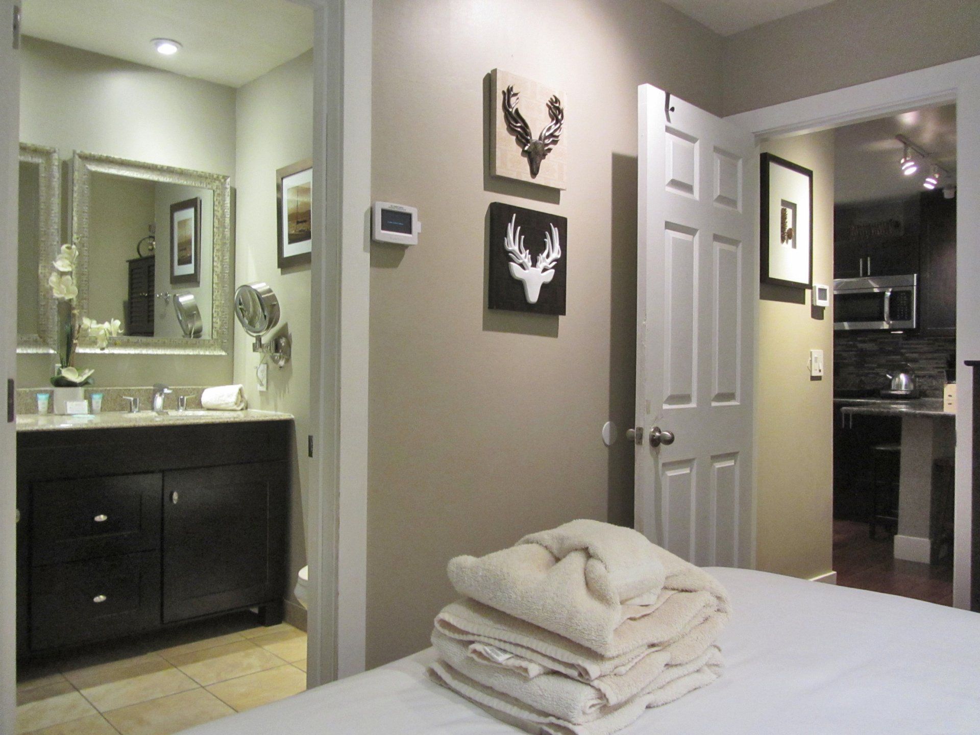A bedroom with a large bed and a bathroom