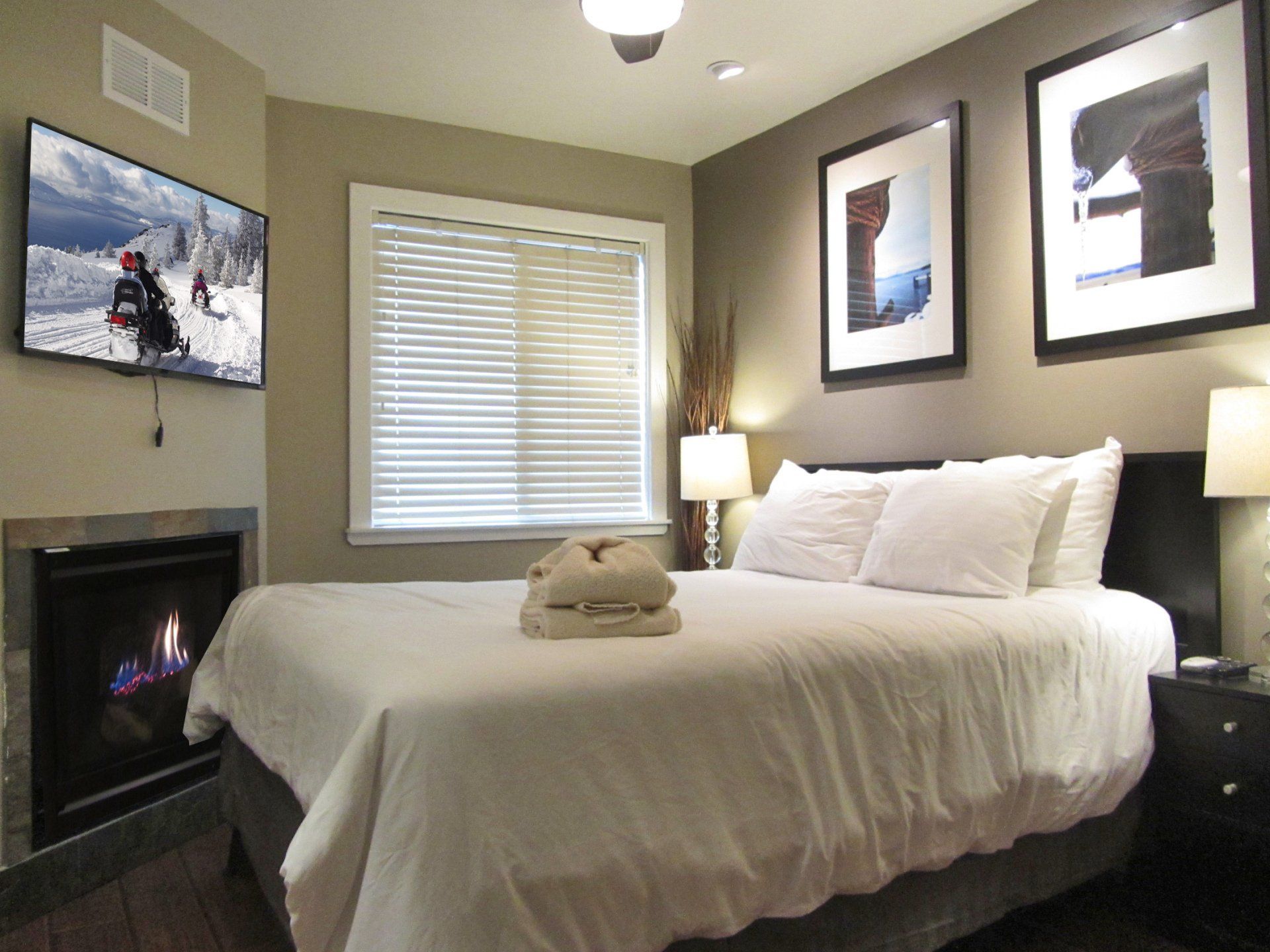 A bedroom with a king size bed and a fireplace