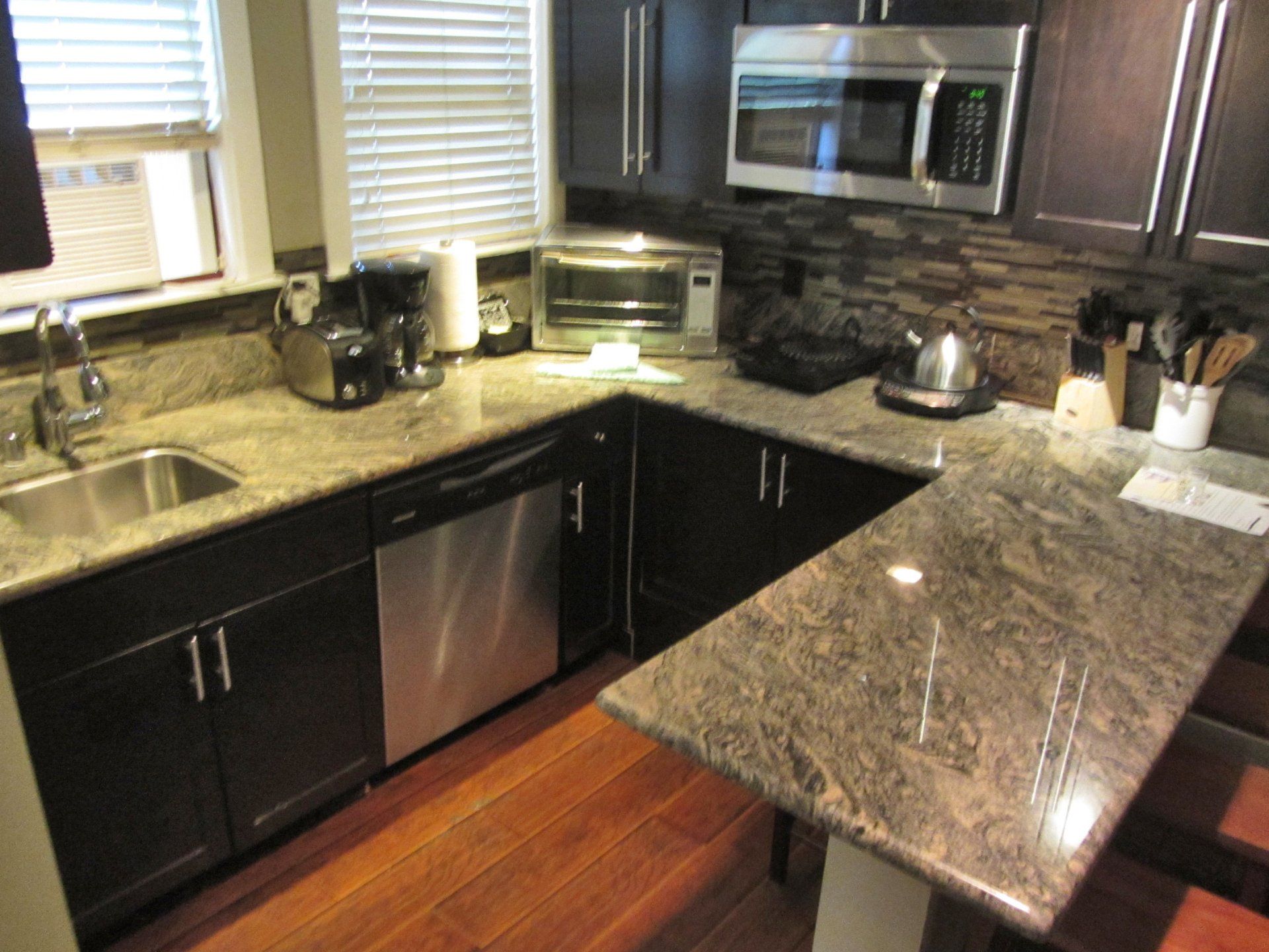 A kitchen with granite counter tops and stainless steel appliances