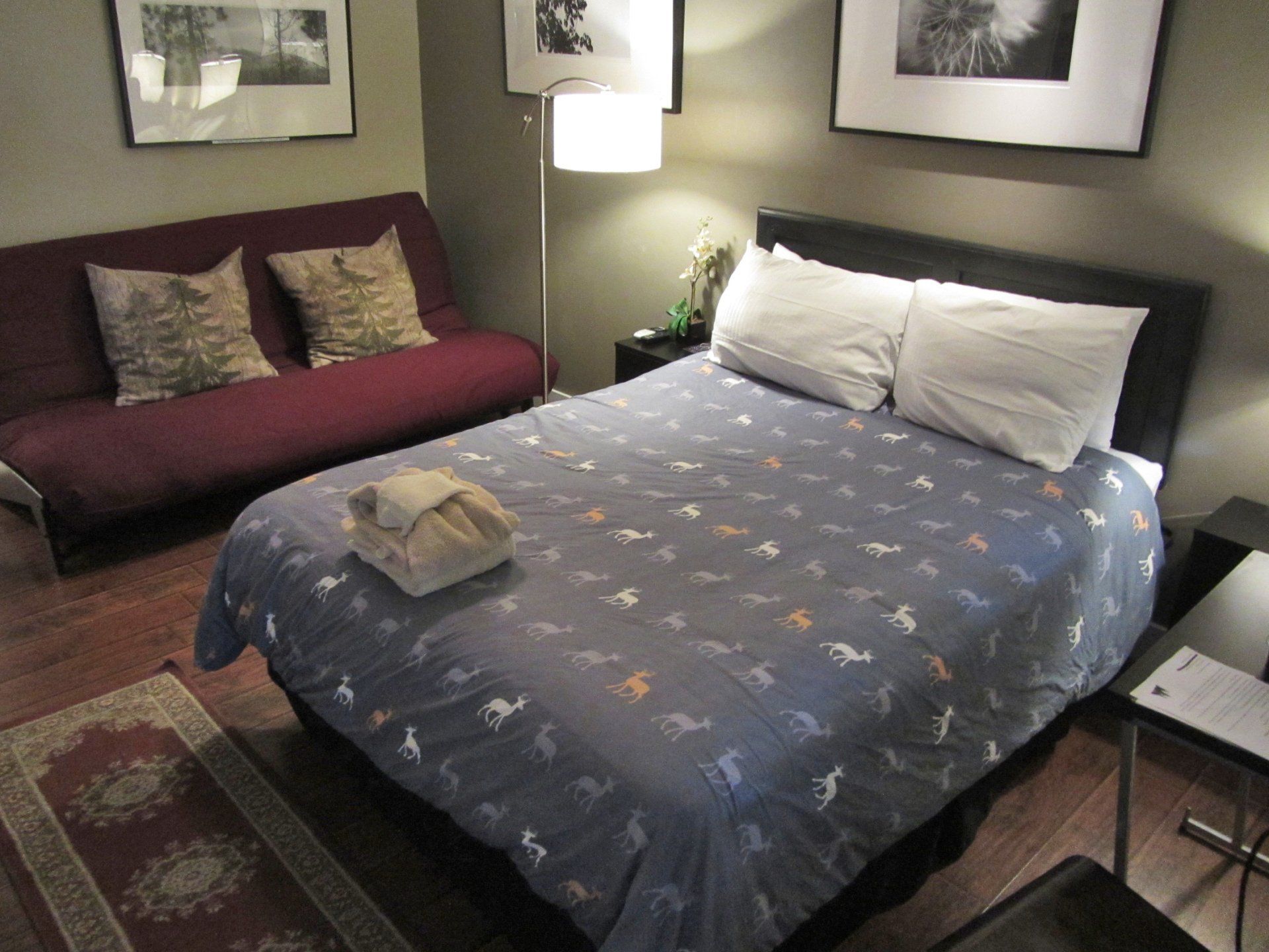 A bedroom with a large bed and a futon