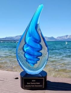 A blue glass trophy that says best tasting water on it
