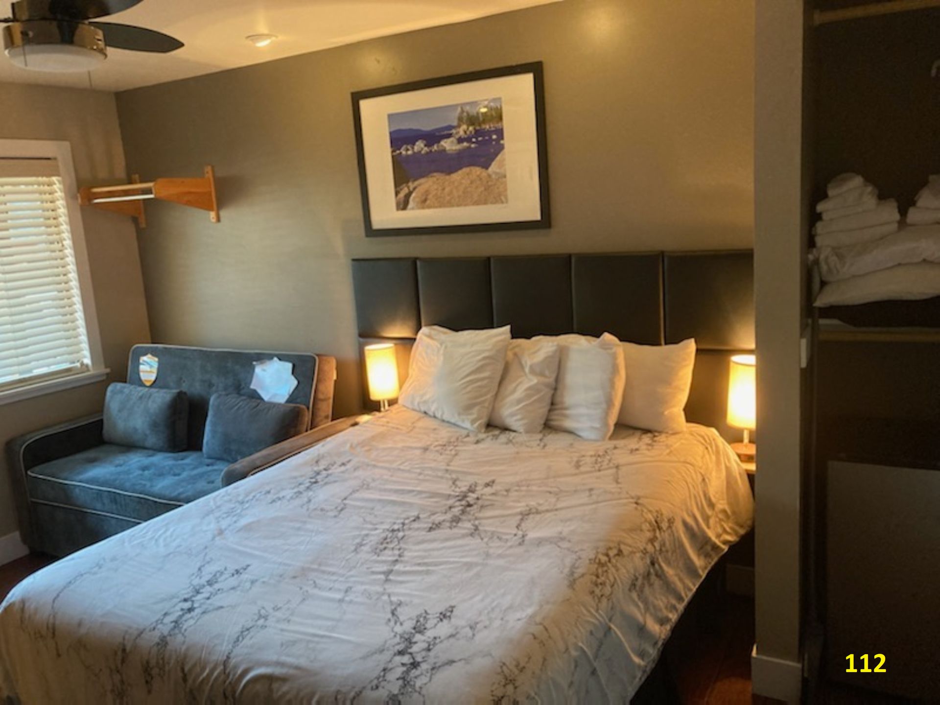 A hotel room with a large bed and a couch