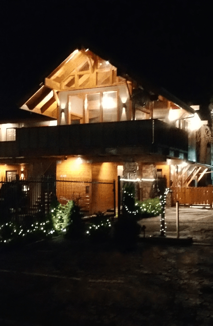 A large house that is lit up at night