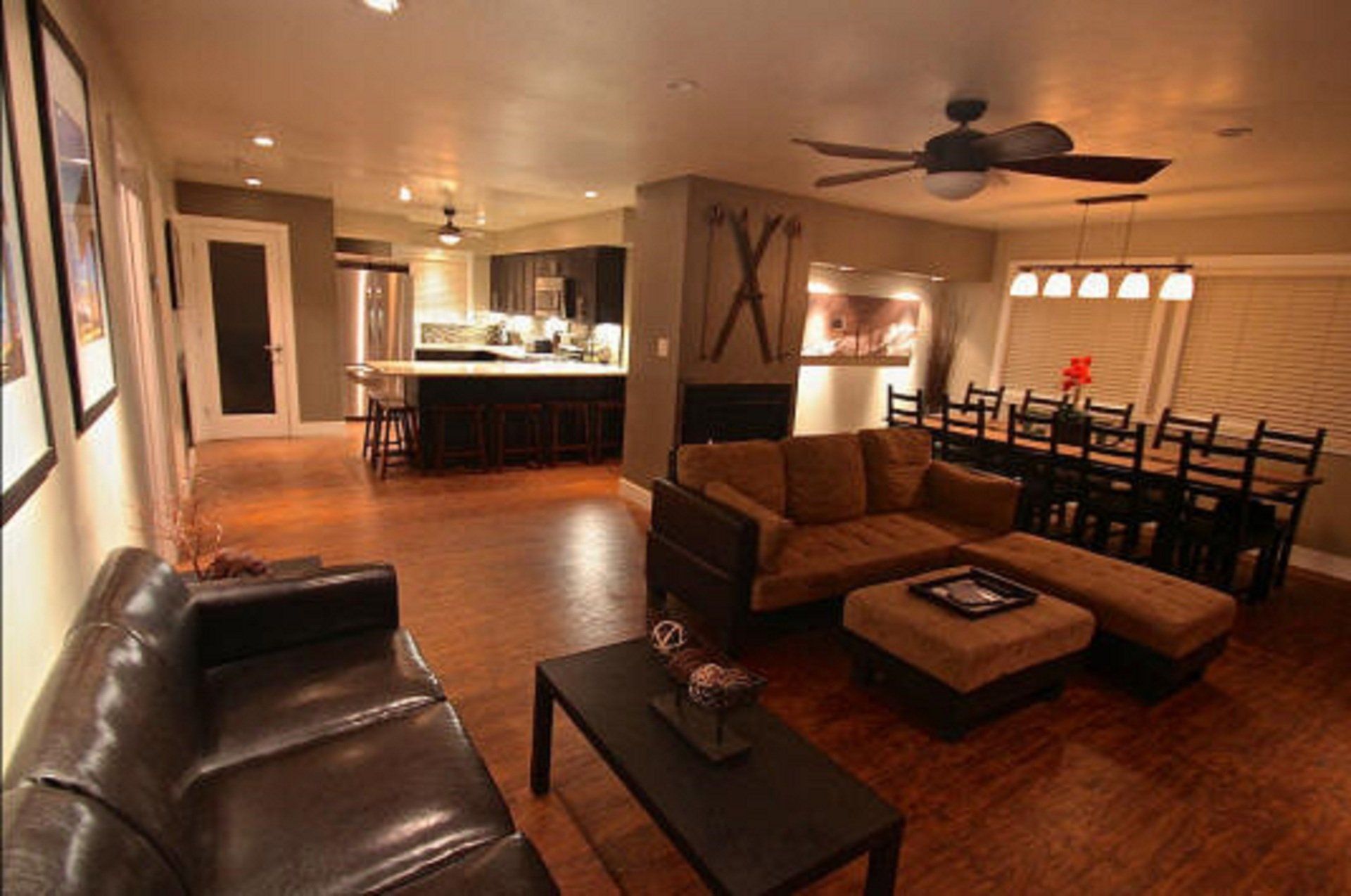 A living room with a couch a coffee table and a ceiling fan