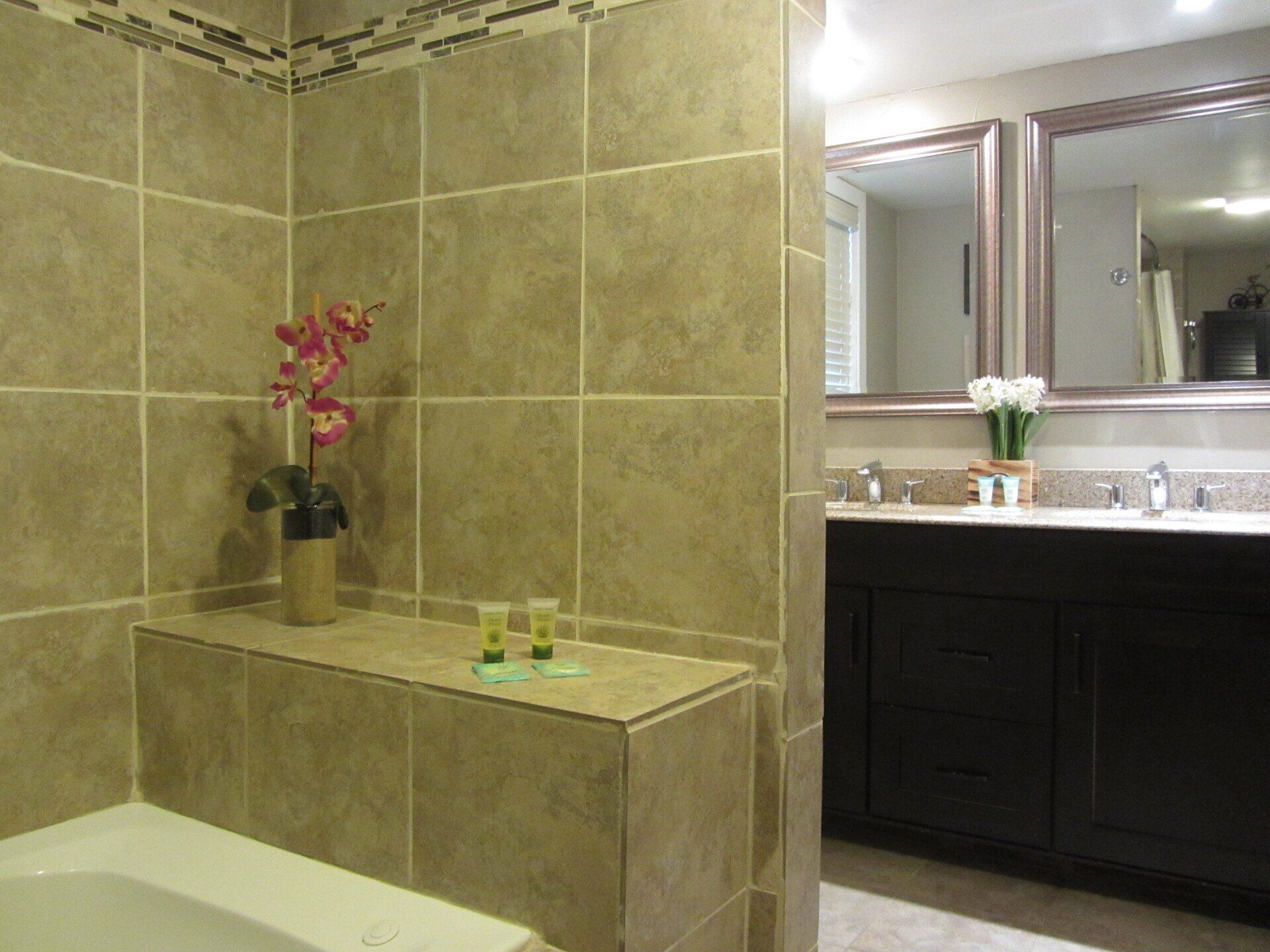 A bathroom with a bathtub and two sinks