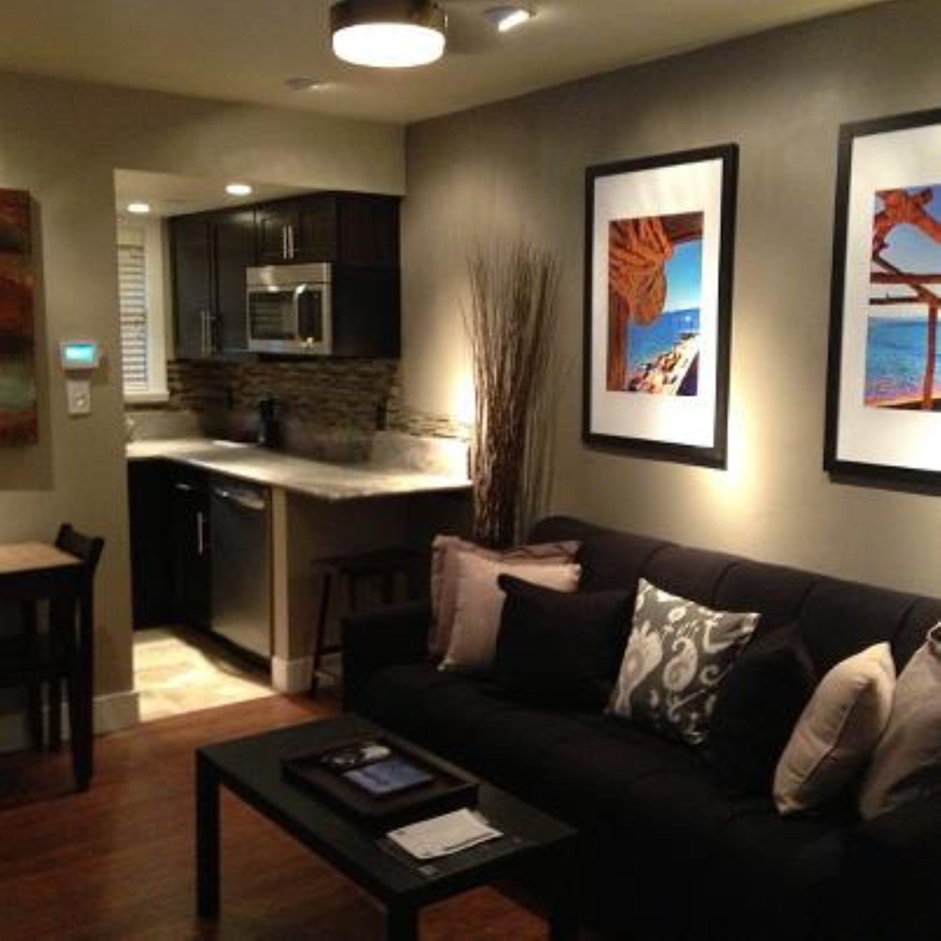 A living room with a black couch and a coffee table