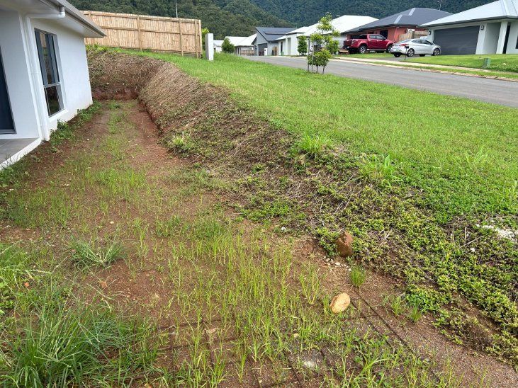 A House with A Lot of Grass and Dirt in Front of It — NQ Parks and Gardens in Cairns, QLD