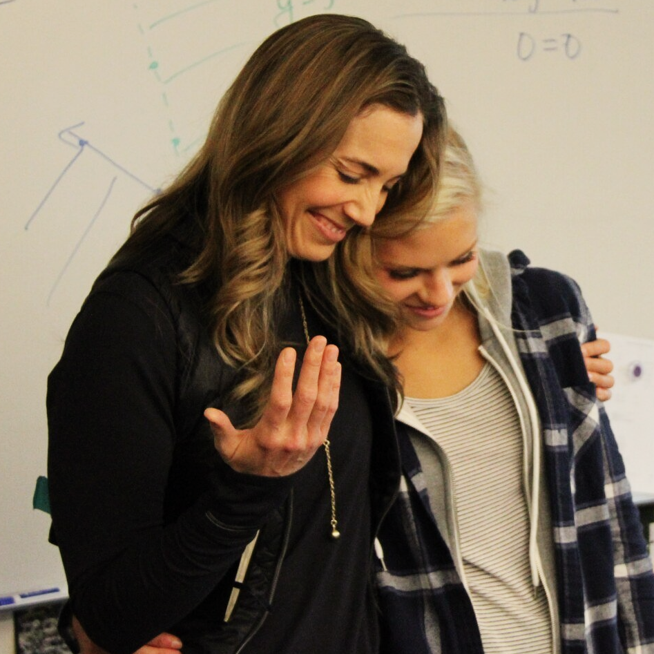 Female soccer coach teaching a young female athlete