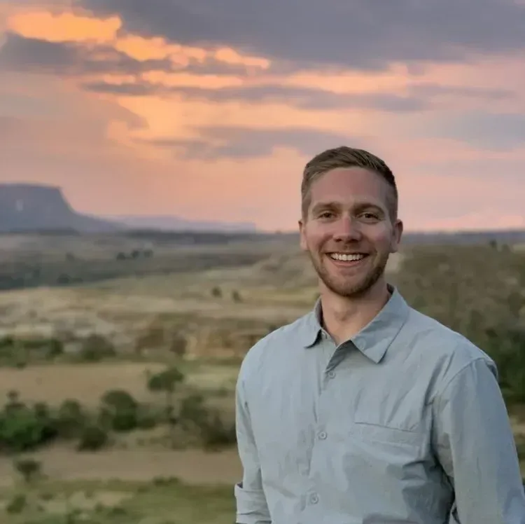 Man with sunset behind him