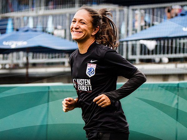 Stephanie Cox smiling, playing on field