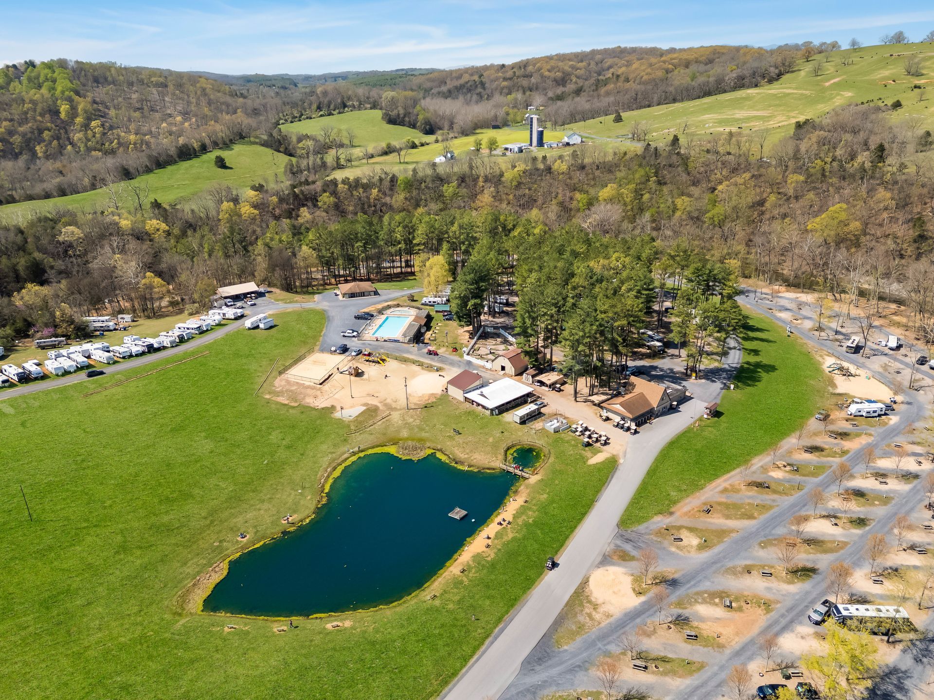 An aerial view of a campground with a small pond in the middle.
