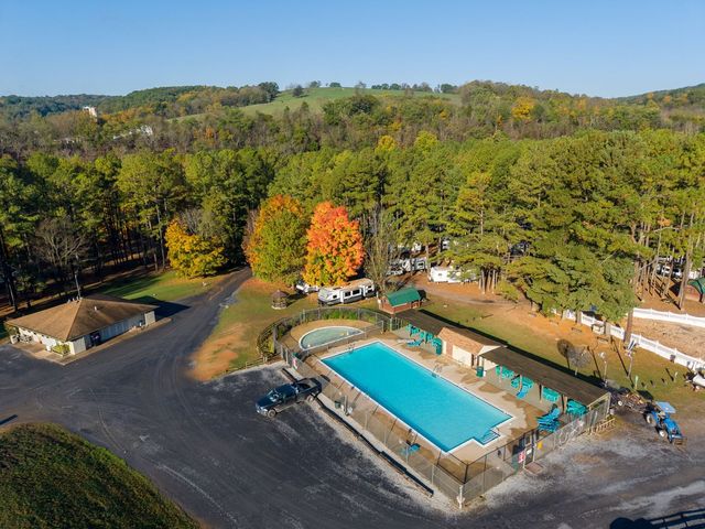 Aerial of the heated pool and tree-shaded sites in fall