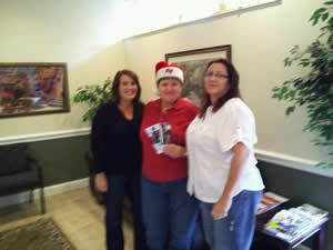 Three women are posing for a picture in a waiting room