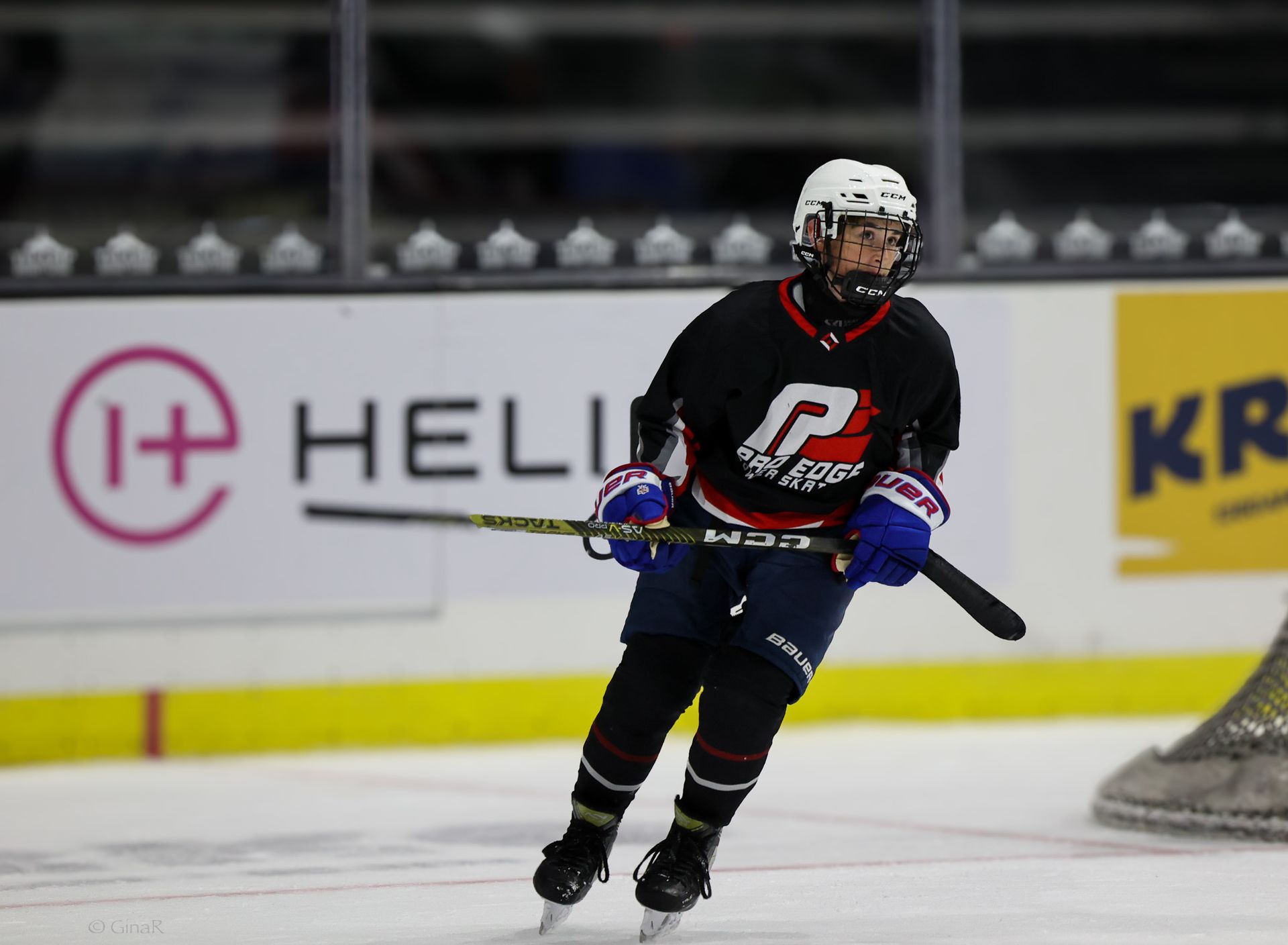 Ice hockey player in black and red skates near the goal during a game