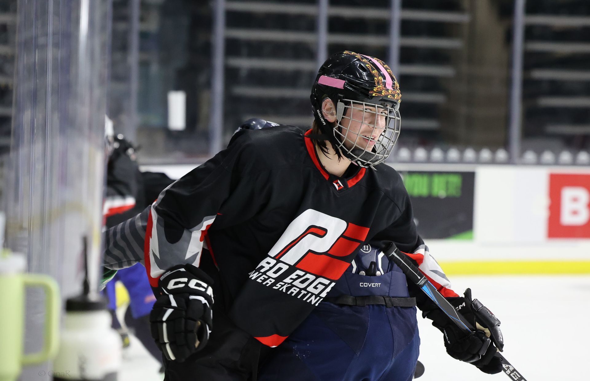 Ice hockey player in black jersey skating on the rink during a game