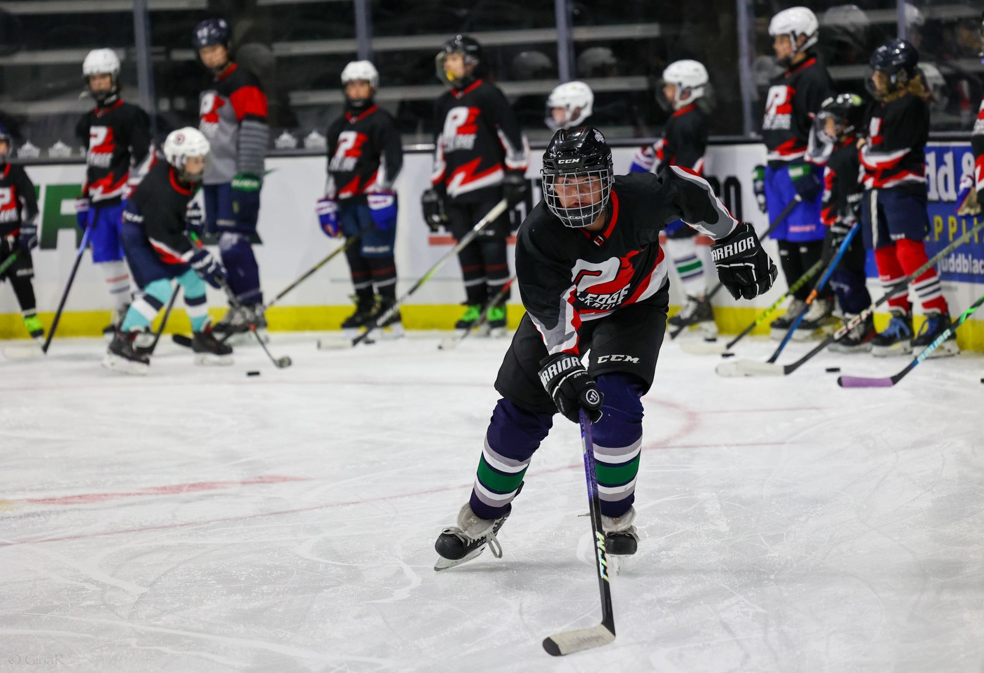 Ice hockey players in black and white uniforms skating on the rink during a game