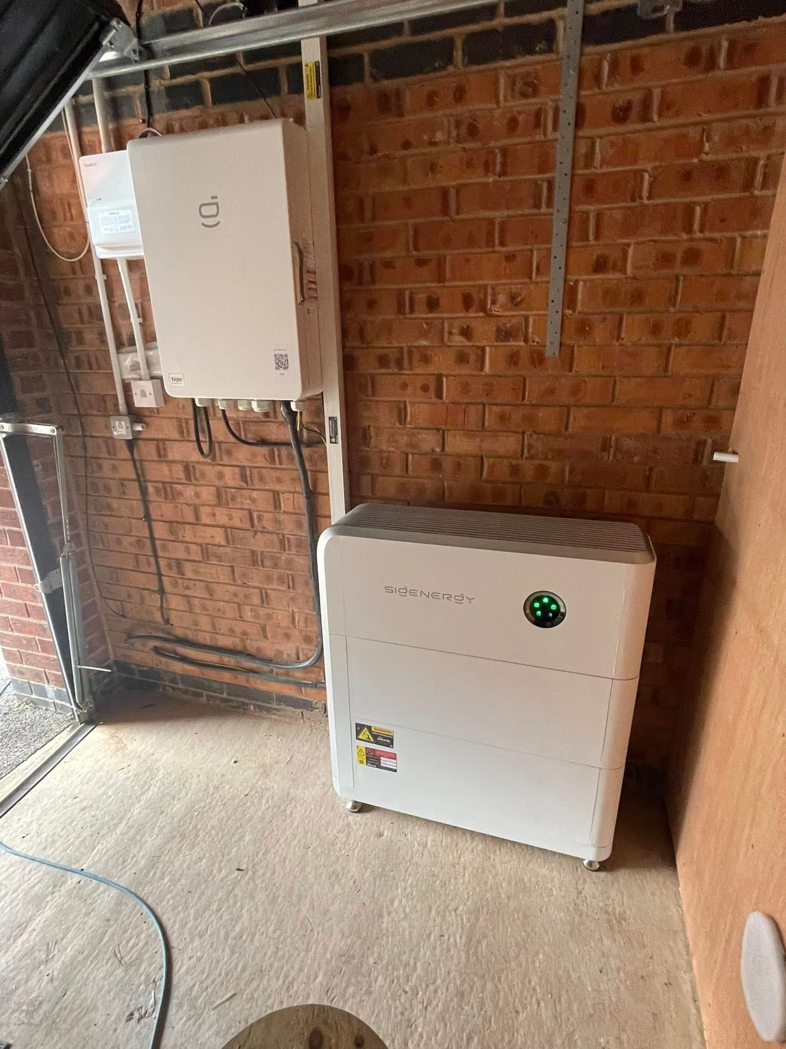 White electrical boxes mounted on a brick wall, likely an outdoor installation.